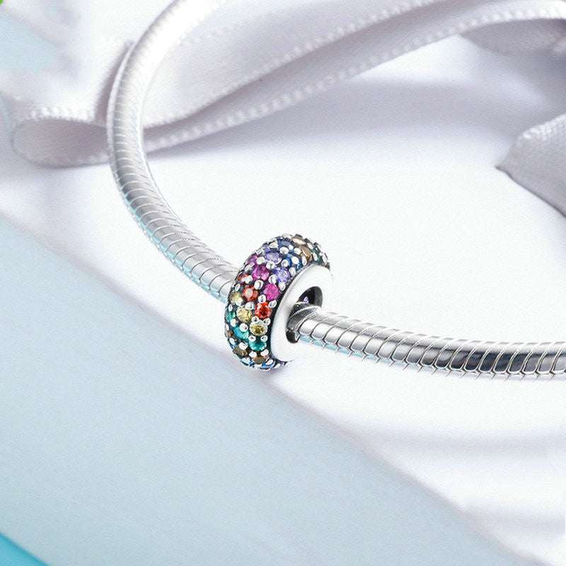 Close-up of sterling silver rainbow beads with colorful zircon accents for DIY crafts and jewelry making